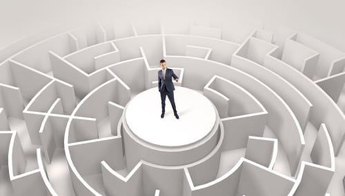 Business man standing on top of a maze