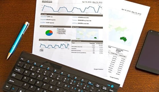 Google report open on a desk, with a computer keyboard.