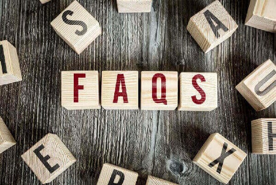 Wooden blocks with the word FAQS on the table.