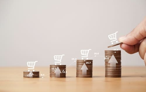 Growing stack of coins, standing next to each other.