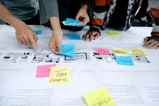 People working on a journey map with sticky notes